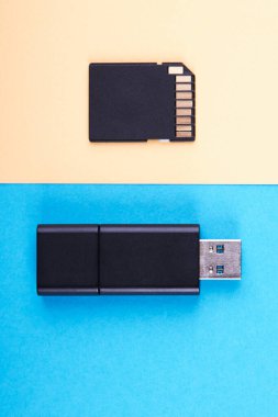 USB flaş bellek ve mikro hafıza kartı mavi ve sarı arka planda. farklı tür taşınabilir depolama cihazları. veri depolama kavramı