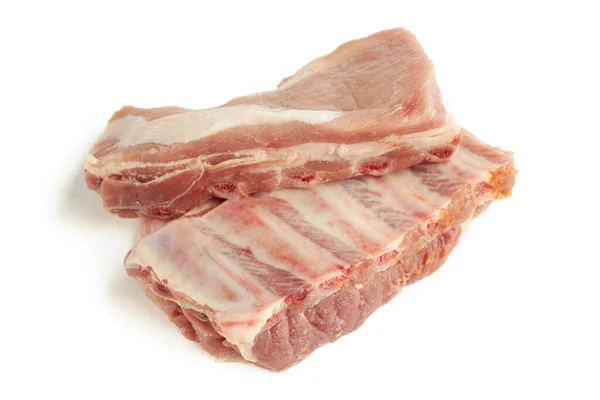 Fresh raw pork ribs isolated on a white background. two pieces. ingredient for meat cuisine. side view — Stock Photo, Image