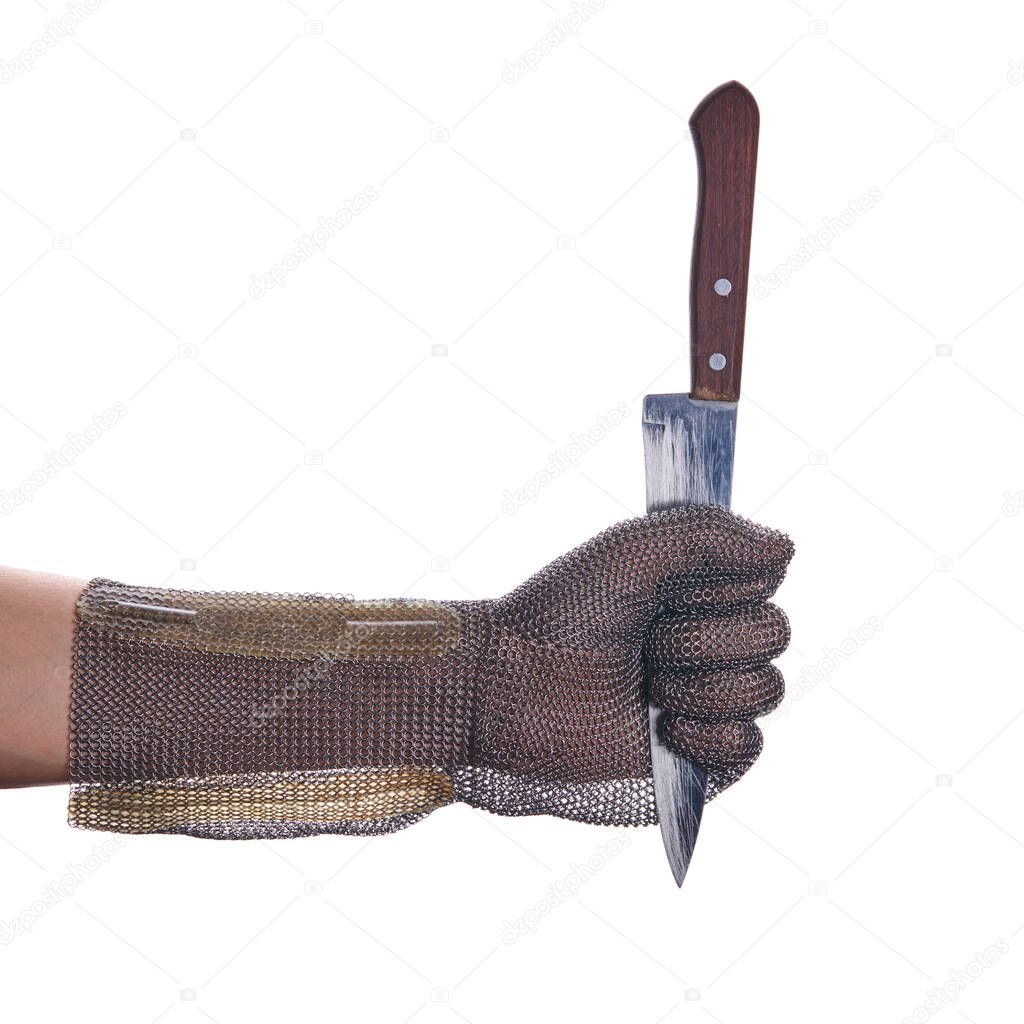 chain mail armor glove. person holds a kitchen knife by the blade. isolated on a white background
