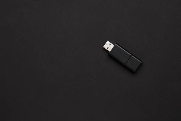 portable device technology concept. usb flash memory stick. view from above. black on black