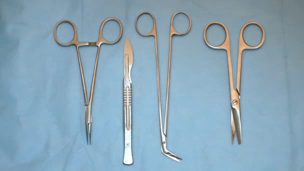 Multiple surgery instruments on blue table above view. surgeon take surgical tools from table — Stock Video