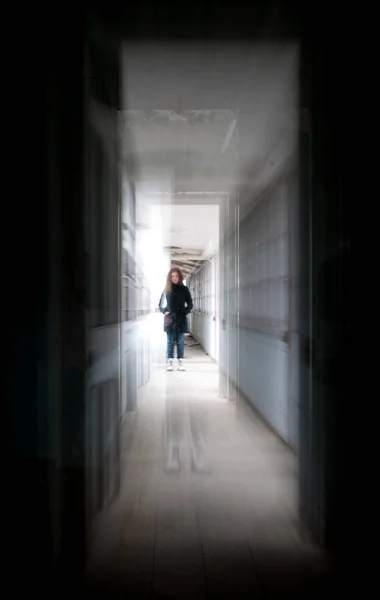 Dark creepy dark hall with a woman in the center — Stock Photo, Image