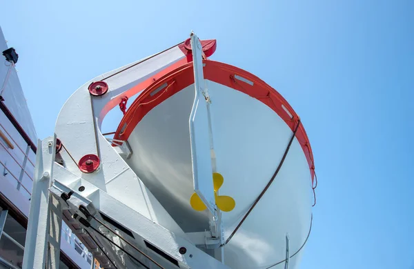 Barco salvavidas en un barco contra el cielo azul. Salvamento de vida en el océano — Foto de Stock