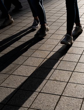 Silhouette of unrecognized people walking in the street.