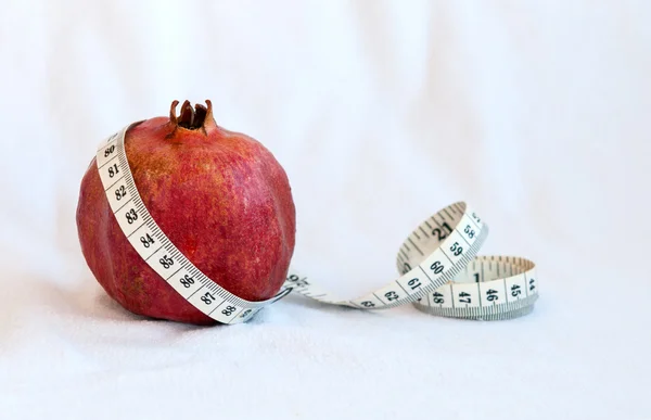 Granátové jablko ovoce a měřicí pásky — Stock fotografie