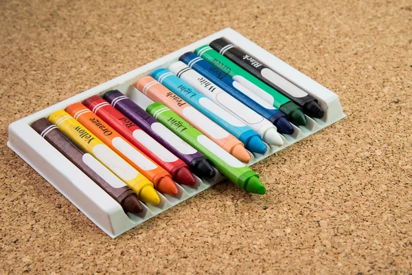 Color drawing crayons on a cork board — 图库照片