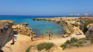 Protaras, cyprus, June 8 2025: Tourists relax and swim at a scenic beach cove under clear sky. Remote isolated beach Protaras Cyprus