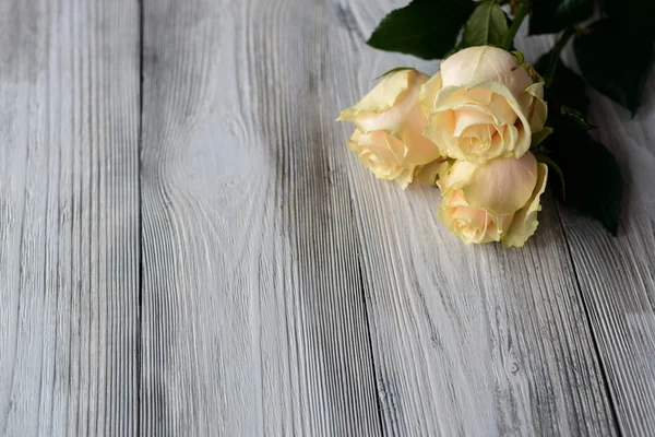 Flowers on grey cracked wooden floor — Stock Photo, Image