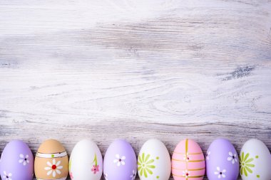 Pastel colors Easter eggs on a grey wooden background.