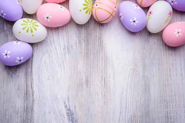 Colorful Easter eggs on old cracked wooden background — Stockfoto