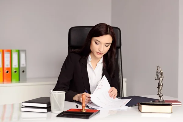 Brunette woman Notary Public reading and signing testament — Stock Photo, Image