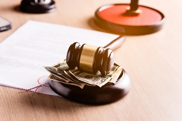 Money under the judge's gavel — Stock Photo, Image