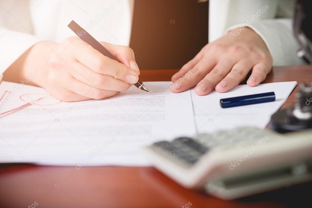 Notary Public signing the contract in her office. Law office