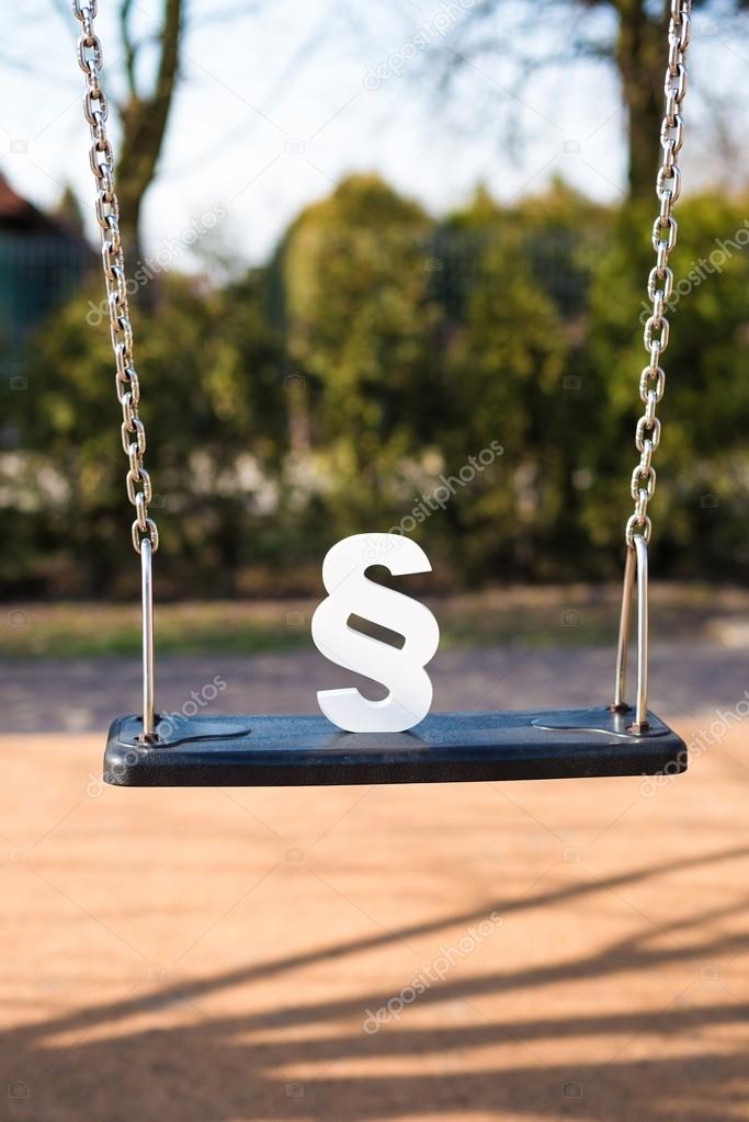 White paragraph symbol on children chain swing.