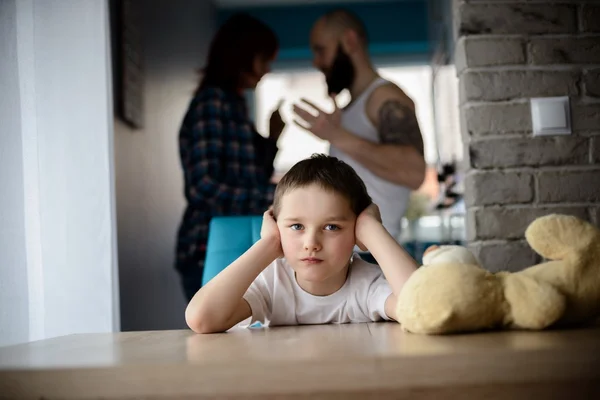 Sad, desperate little boy during parents quarrel — Stock Photo, Image