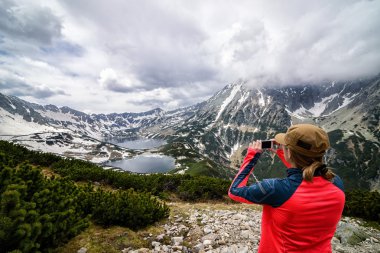 Young woman taking photo of 5 Ponds Valley