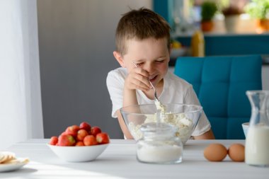 Child mixing white cottage cheese in a bowl