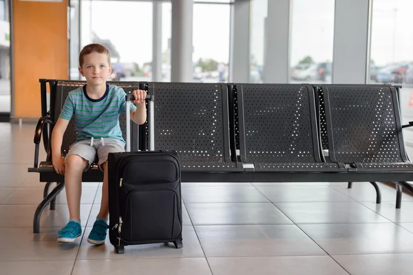 Child boy waiting in waiting room for passengers