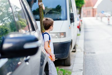 Little 7 years old boy during his road to school. clipart