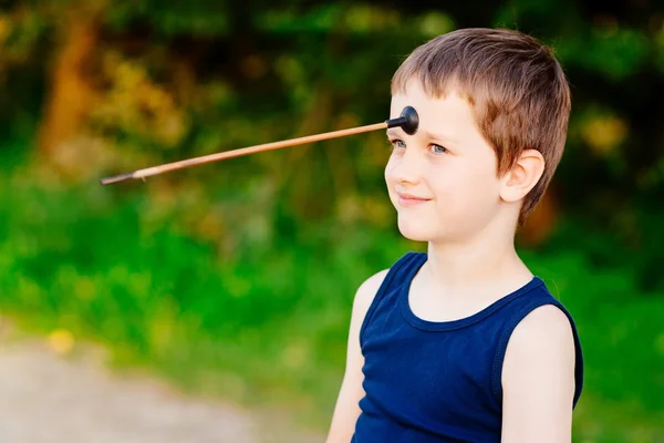 Boy playing playing with bow and toy arrow — Stock Photo, Image