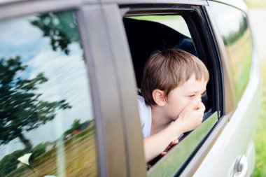 Child suffers from motion sickness in car clipart