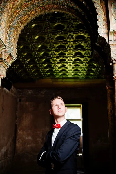 Portrait of young groom in an old house. — Stock Photo, Image