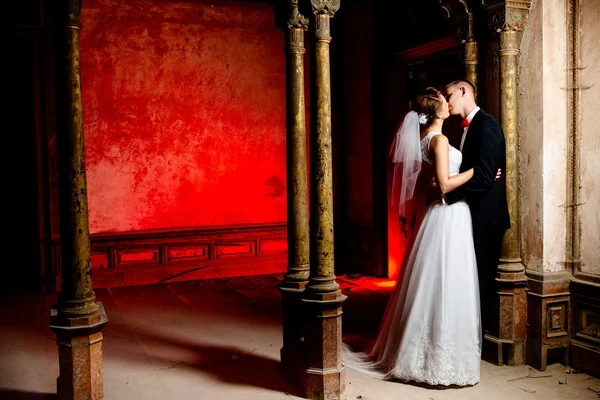 Bride and groom kissing in the old palace. — Stock Photo, Image