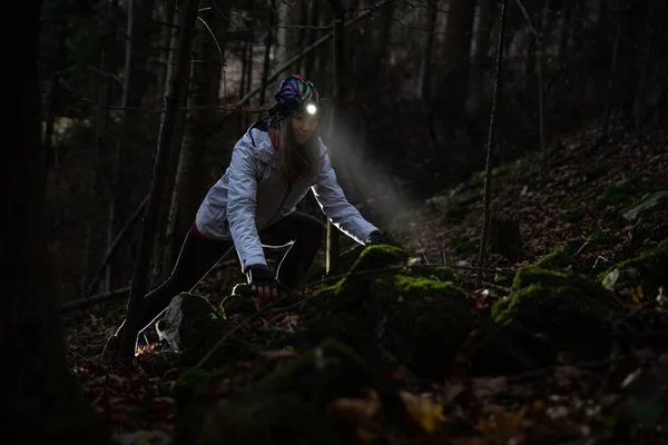 Beauty tourist woman with headlight in the forest — Stock Photo, Image