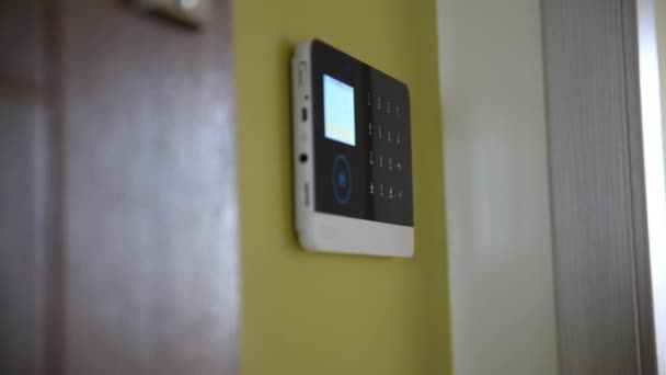 Närbild av en mans hand avväpna sitt hem säkerhetssystem med hjälp av en larmfjärrkontroll. — Stockvideo