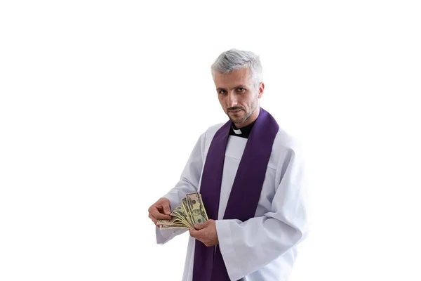 Greedy catholic priest counting money american dollars. Isolated on white background