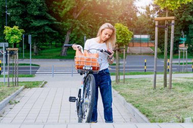 The cyclist has a problem. Hes going up the stairs trying to bring the bike.
