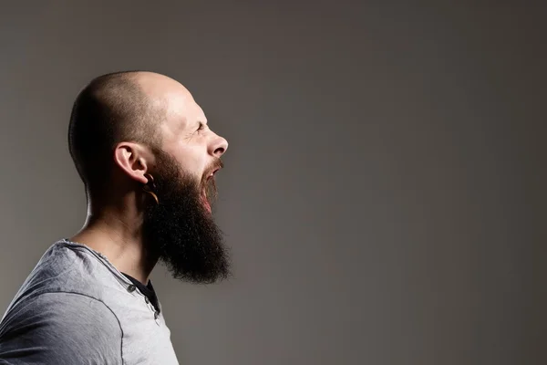 Side view portrait of screaming bearded man — Stock Photo, Image