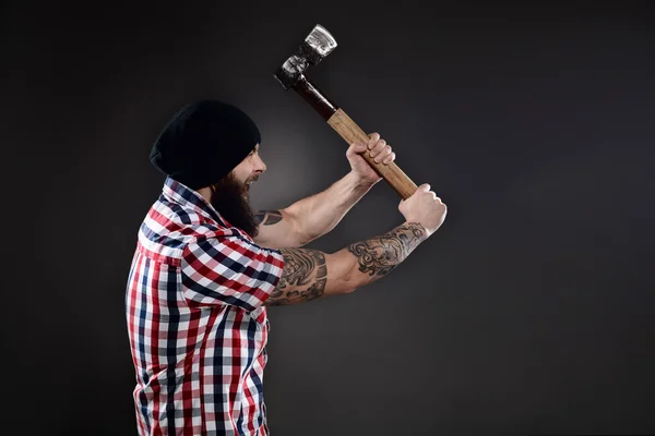 Furious lumberjack man swinging his axe — Stock Photo, Image