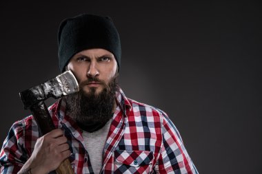 Bearded man in a black hat holding a old ax clipart