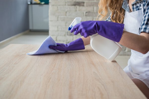 Female hands cleaning table
