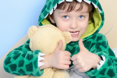 Portrait of little 6yrs boy gesturing thumbs up  clipart