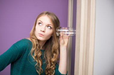 Curious young woman with glass clipart