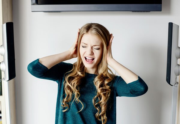 Woman covers her ears