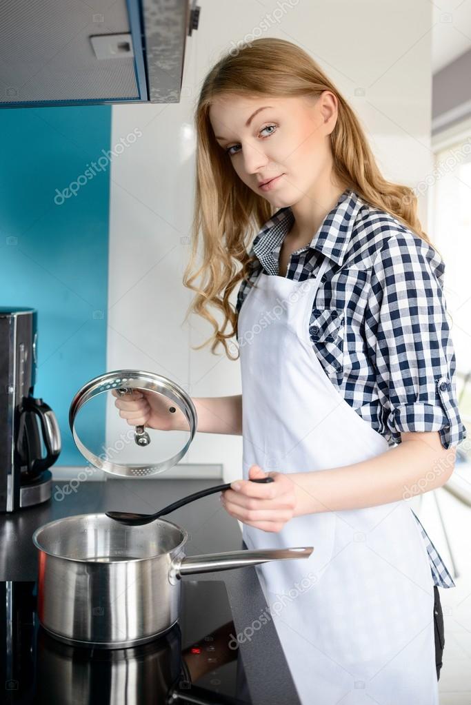 Beautiful blonde woman cooking