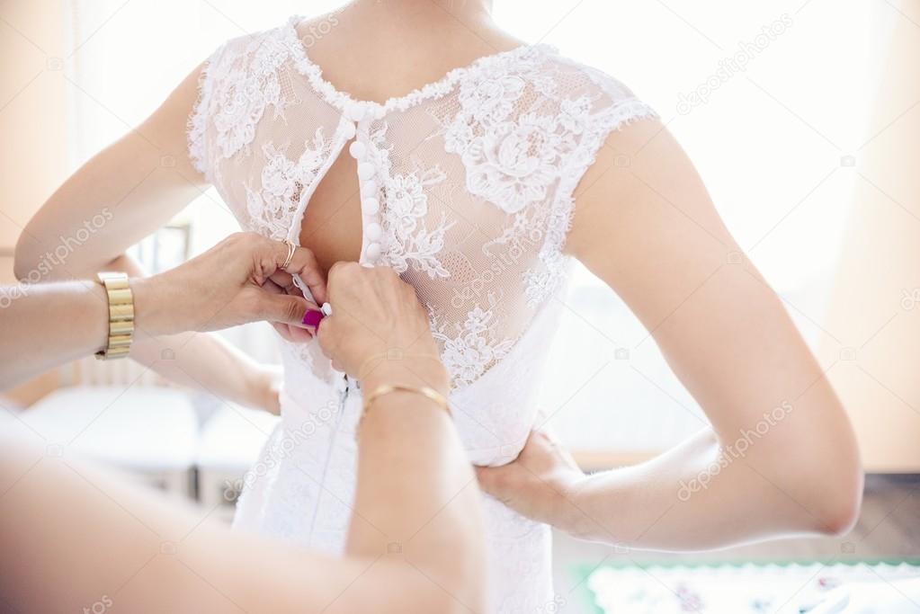 Putting on wedding dress