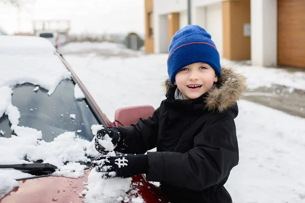 Kind spelen met sneeuw buiten. — Stockfoto