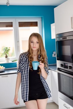 Genç sarışın kadın kahve veya çay bardağı içme