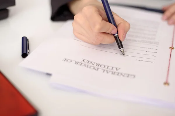 Close-up of a woman's hand filling a power of attorney — Stock Photo, Image