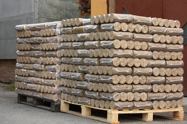 Wood briquettes on pallets — Stock Photo, Image