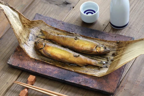 A fuego lento ayu (pez dulce) con pimienta japonesa, y sake (vino de arroz japonés  ) —  Fotos de Stock