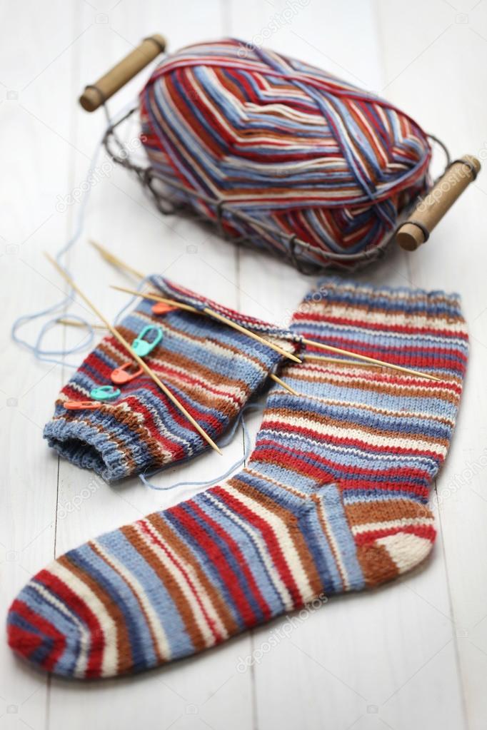Knitting winter warm socks, yarn ball and knitting needles