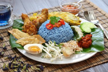 Nasi kerabu, blue color rice salad, malaysian cuisine clipart