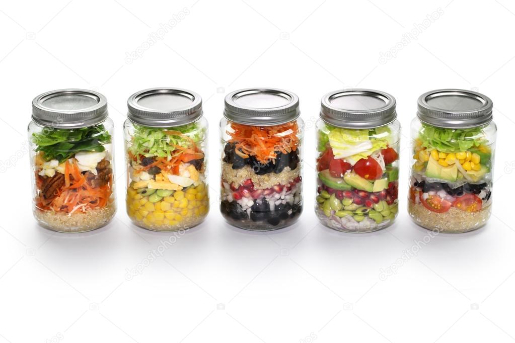 Vegetable salad in glass jar, white background