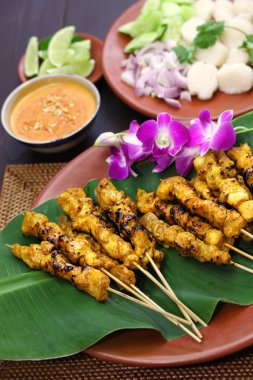 Chicken satay with peanut sauce, indonesian skewer cuisine clipart