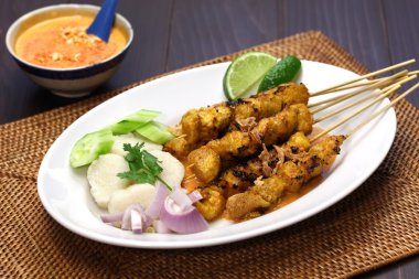 Chicken satay with peanut sauce, indonesian skewer cuisine clipart